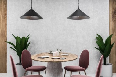 Beton ve ahşap duvarlar, beton zemin, modern kafe tabloda yuvarlak ahşap masa ve iki tavan lambaları duran kırmızı sandalye ile. 3D render