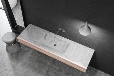 Üstten görünüm siyah duvar ve şık tavan lambası ile odada ahşap tezgah üzerinde duran beyaz banyo lavabo. 3D render
