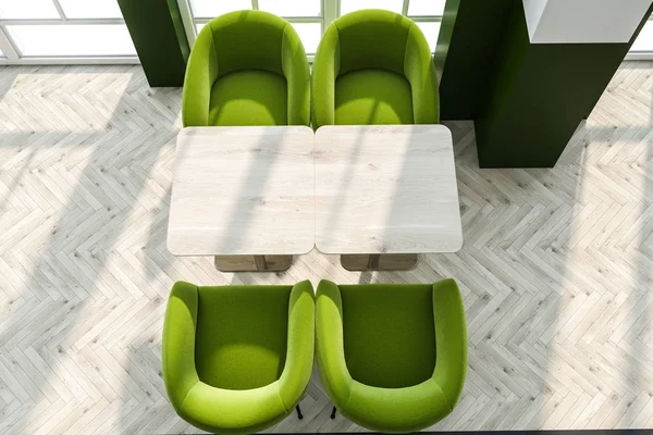 可欣赏到木制咖啡桌和绿色扶手椅的顶部景色 位于现代咖啡厅内部 拥有绿色和白色的墙壁以及木地板 — 图库照片