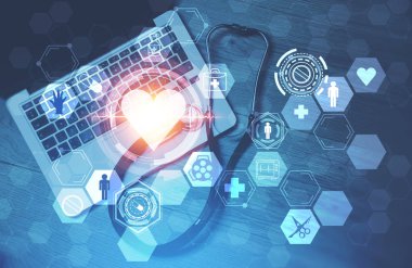 Üstten görünüm ile dizüstü bilgisayar ve bir steteskop ayakta ahşap tablo. Çift Pozlama kalp ve tıbbi arayüzü. Kavramı Merhaba tıpta teknoloji. Tonlu görüntü