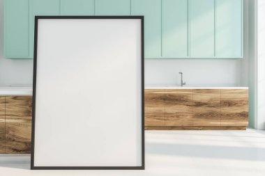 Beyaz duvarlar ve zemin, mavi ve beyaz ve ahşap mutfak tezgahı ve yere dikey poster ile modern mutfak iç. 3D render alay