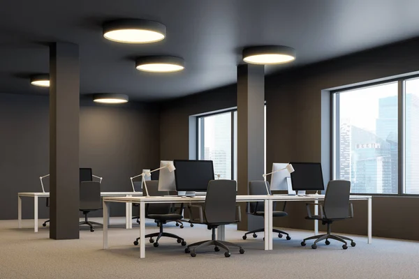 Corner of industrial style office with brown walls, carpet on the floor, columns and rows of white computer tables with brown chairs. Windows with cityscape. 3d rendering