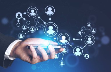 Smartphone insanlar ağ arabiriminin çift pozlama ile koyu mavi arka plan üzerinde tutan işadamı el. Tonlu görüntü