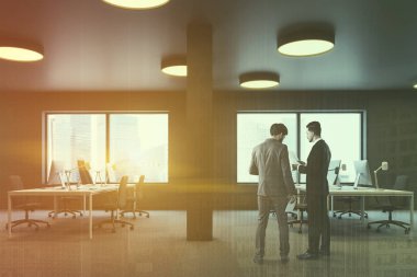 Endüstriyel stil office halı zemin, sütunlar ve kahverengi sandalye ile beyaz bilgisayar tabloları satırları üzerinde kahverengi duvarlı yan görünüm. Windows ile cityscape. İşadamları Toned görüntü çift pozlama