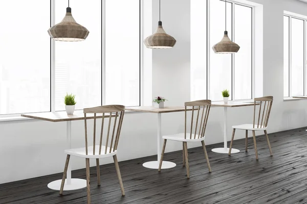 Interior of loft cafe with white walls, wooden floor, square wooden tables and white and wooden chairs standing near them. 3d rendering