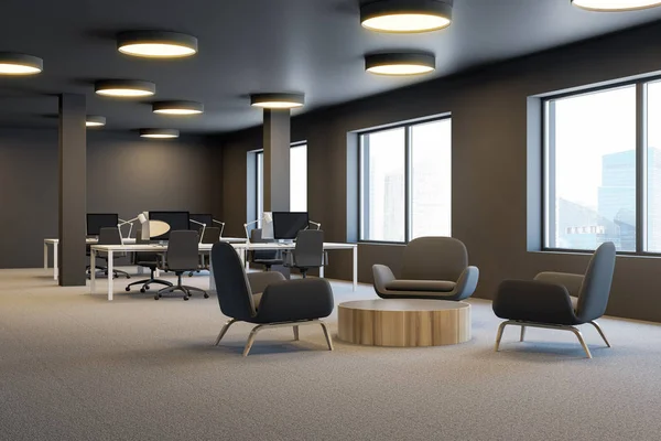 Corner of industrial style office with brown walls, columns, open space area with white computer tables and lounge area with round coffee table and brown armchairs. 3d rendering