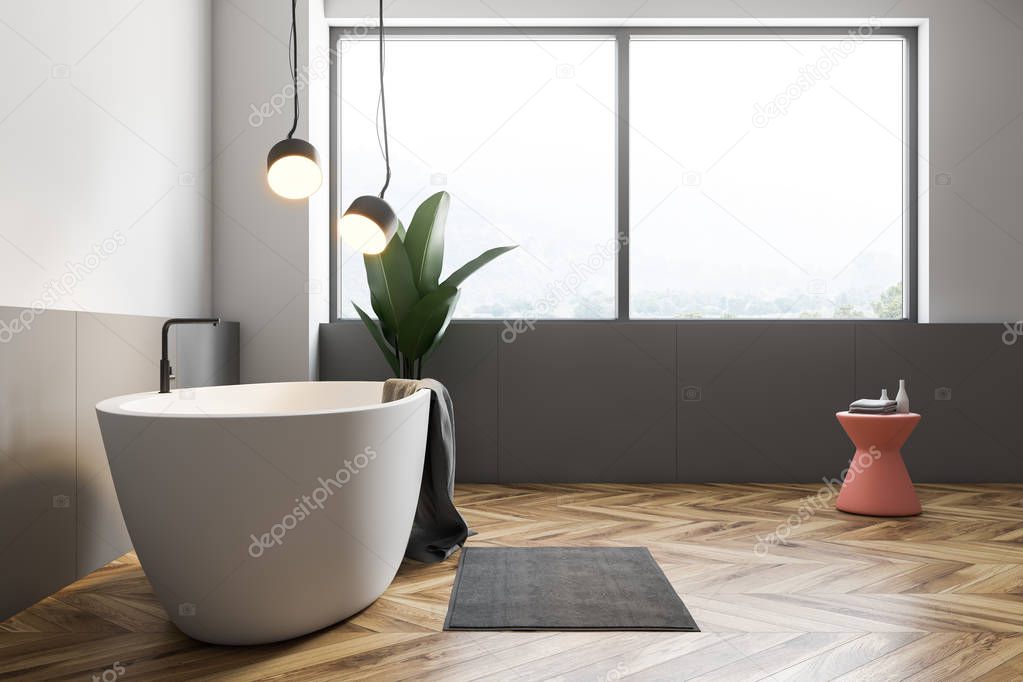 Minimalistic bathroom interior with white and gray walls, wooden floor, large window, white bathtub with gray towel on it and pink chair. Potted plant. 3d rendering
