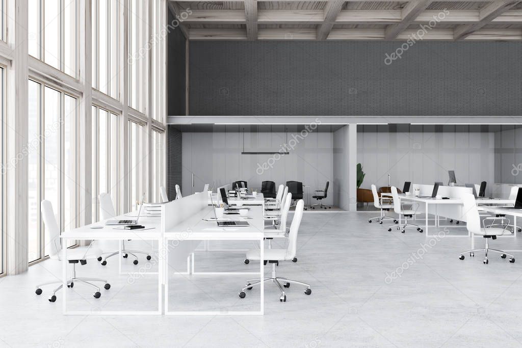 Loft open space office interior with white and gray brick walls, concrete floor, wooden ceiling and rows of white computer tables with laptops. Meeting room in the background. 3d rendering