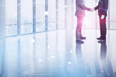 Boş ofis lobisinde ağ hologram ve cityscape çift pozlama ile el sıkışan iki tanınmaz işadamları. Tonlu görüntü