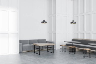 Beyaz duvarlar, beton zemin, uzun gri kanepe yuvarlak siyah tablolar ve ahşap sandalye ve ahşap masa yakınındaki gri kanepe yakın duran modern kafe köşesinde. 3D render