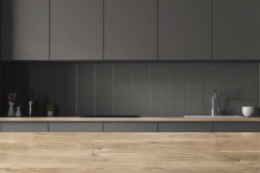 Modern mutfak gri döşeli duvarlar ile iç, gri ve ahşap mutfak tezgahı ile inşa tekniği ve gri dolabı. Tablo ön planda. 3d render bulanık