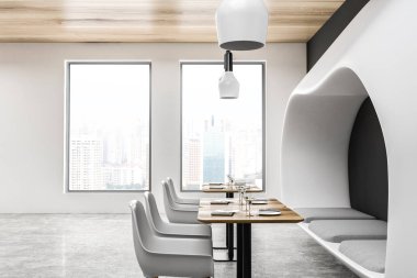Gri ve beyaz duvarlar, beton zemin, beyaz koltukları ve orijinal beyaz kanepe ile ahşap masa ile modern restoran iç. 3D render