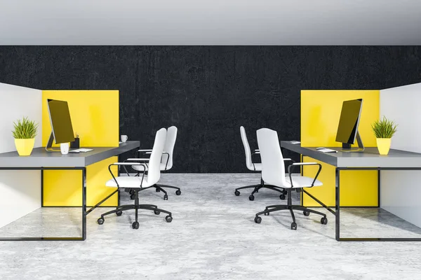 Interior of office with black walls and concrete floor and white and yellow cubicles with gray computer tables and white chairs. 3d rendering