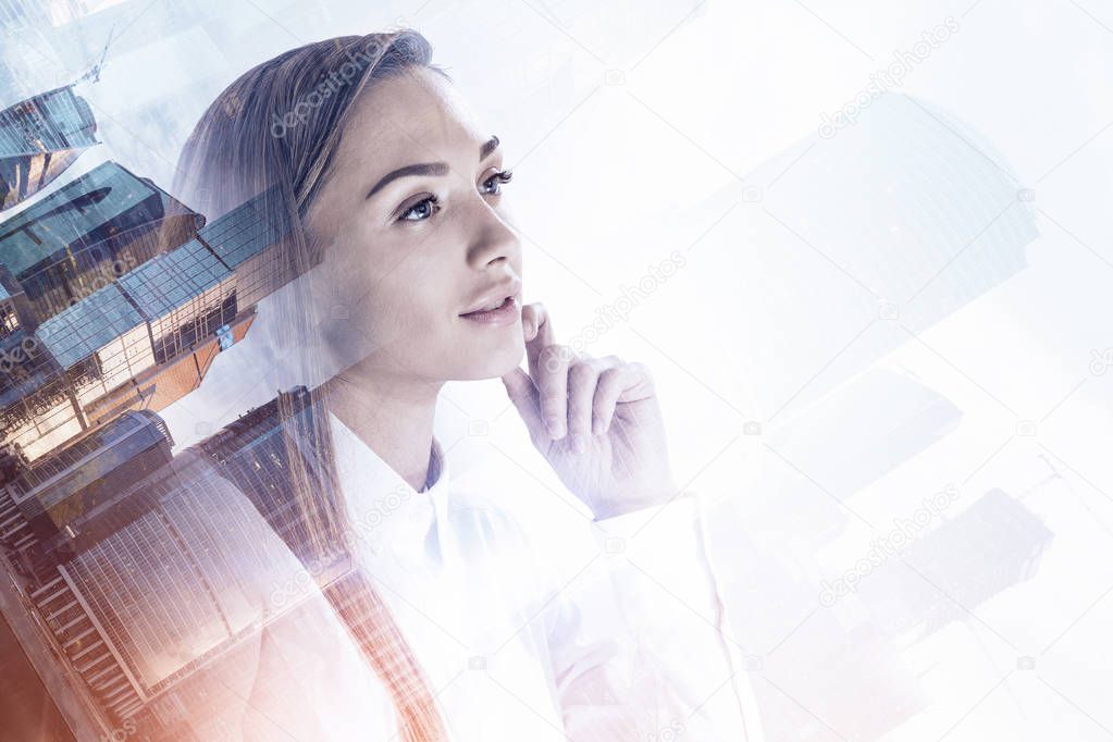 Thoughtful young businesswoman portrait with double exposure of Moscow city panorama. Toned image mock up