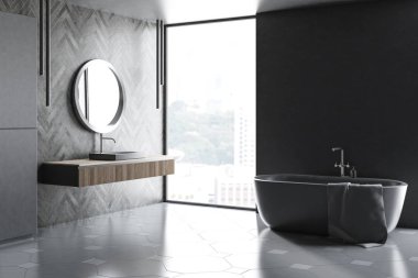 Gri ve siyah ahşap duvarlar, çatı penceresi, gri küvet ve gri lavabo banyo köşesinde yuvarlak ayna üstünde olan ahşap sayaç üzerinde. 3D render