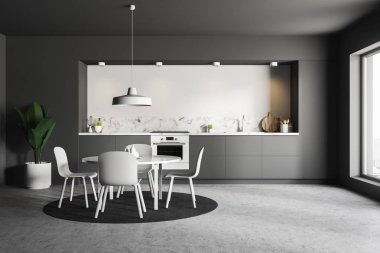 Gri ve beyaz duvarlar, beton zemin, yuvarlak halı üzerinde duran beyaz sandalye ile yapılı içinde Ocak ve beyaz yuvarlak masa ile gri mutfak tezgahı ile modern mutfak iç. 3D render