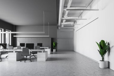 Gri ve beyaz duvarlar, taş zemine, sandalye ve dolap duvarın yanında beyaz bilgisayar tabloları satırları ile modern ofis iç. 3D render