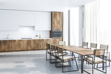 İç beyaz duvarlar, taş zemine, beyaz dolapları ve ahşap mutfak tezgahı ile modern mutfak ve uzun ahşap masa sandalye ile. 3D render