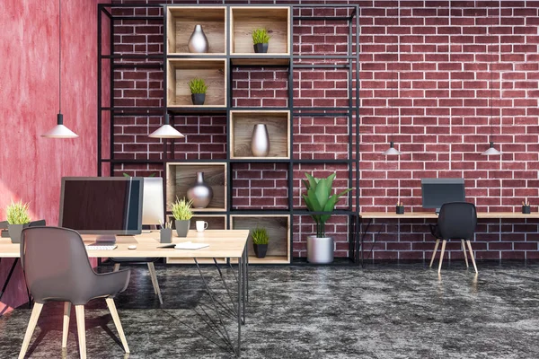 Interior of modern office with red and brick walls, black floor, wooden tables with computers and gray chairs and bookcase with vases. 3d rendering