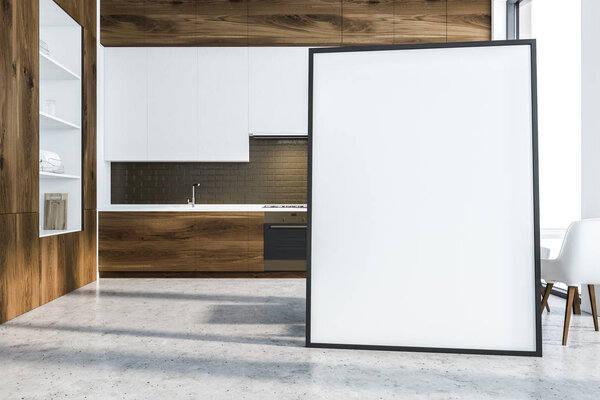 Interior of modern kitchen with black brick walls, concrete floor, wooden countertops and white cupboards and big white and wooden cupboard on the left. Poster on floor. 3d rendering mock up