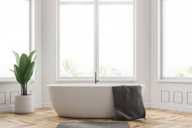 Minimalist banyo beyaz duvarlar, ahşap zemin, büyük pencereler ve gri havluda beyaz banyo küvetinde iç. 3D render
