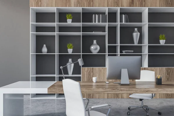 Close up of manager office with gray walls, concrete floor, white and wooden computer table with white chairs and bookcase with vases. 3d rendering