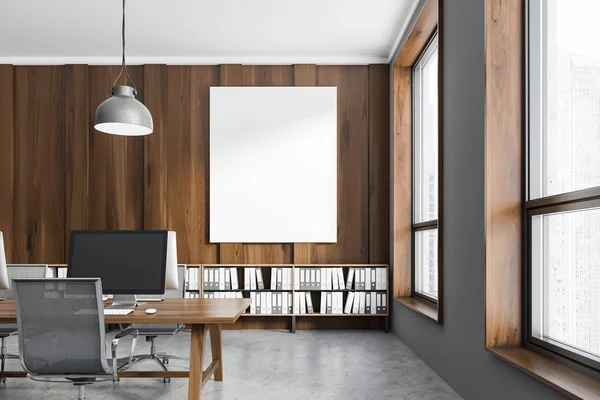 Interior of office workplace with dark wooden and gray walls, concrete floor and dark wooden computer tables. Shelves with folders near the wall. Vertical poster. 3d rendering mock up