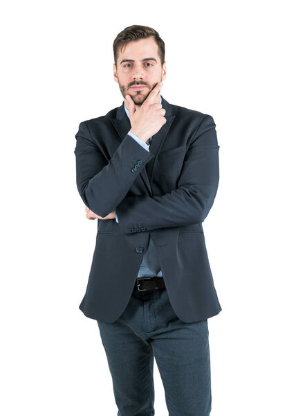 Isolated portrait of thoughtful young businessman with beard wearing dark suit. Concept of decision making