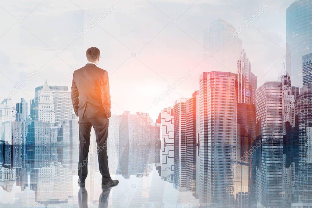 Rear view of businessman in glasses looking at modern cityscape and its reflection. Concept of leadership. Toned image double exposure