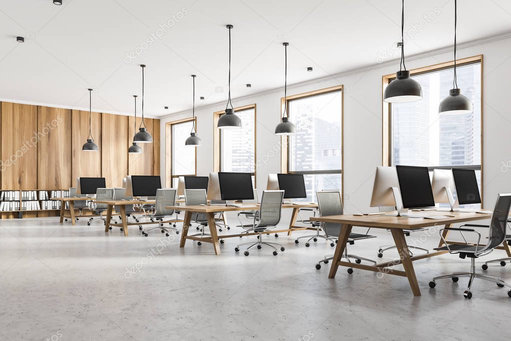 Interior of open space office with white and light wooden walls, loft windows, concrete floor and rows of light wooden computer tables. 3d rendering