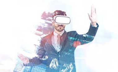 Portrait of young bearded caucasian businessman using vr glasses with double exposure of modern cityscape. Toned image