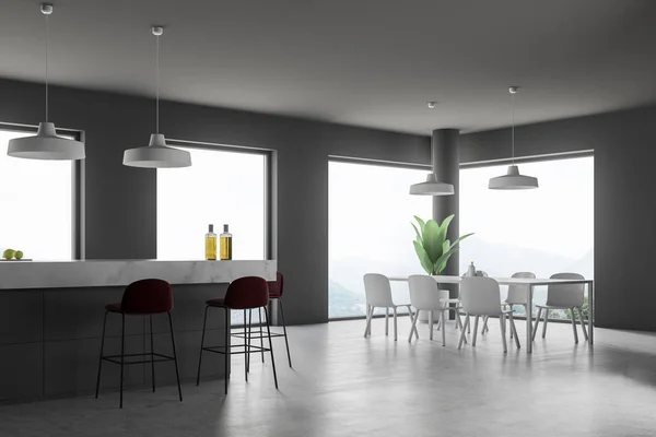 Corner of modern kitchen and dining room with gray walls, concrete floor, white and gray island with dark red stools and white table with chairs. 3d rendering