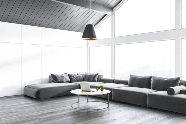 白い壁 灰色の天井 木製床板はグレー 長い灰色のソファーのラップトップで円形のコーヒー テーブルと屋根裏部屋のリビング ルームのコーナー レンダリング — ストック写真