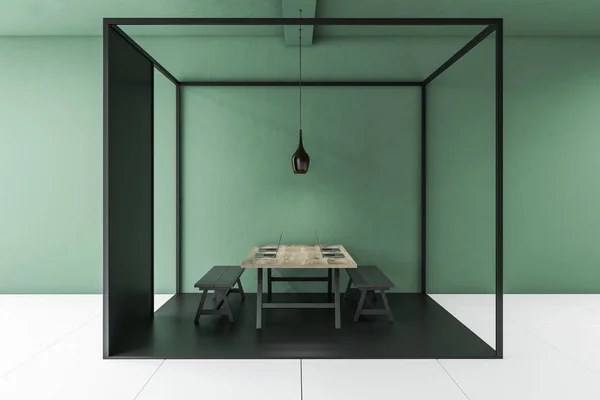 Interior of modern office with green walls, tiled floor, long wooden computer table with black benches standing inside black cube. 3d rendering