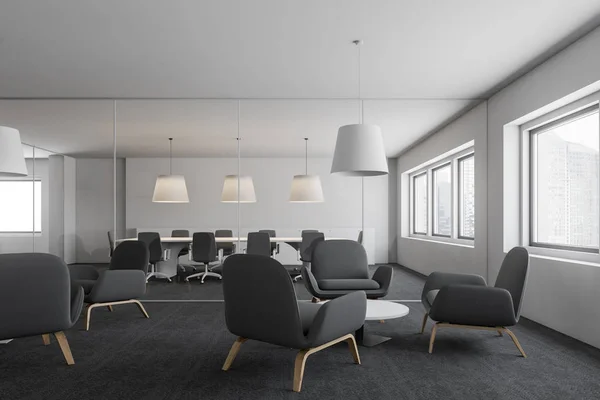 Interior of office lounge with gray armchairs standing near round coffee tables and glass wall meeting room in the background. 3d rendering