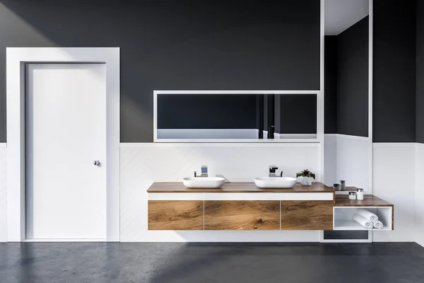现代浴室的内部有白色和灰色的墙壁 混凝土地板 双水槽站在木台面上 上面有垂直和水平的镜子和一扇门 — 图库照片