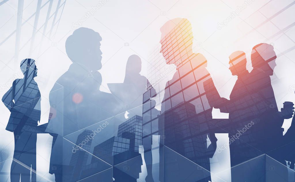 Silhouettes of business people working and communicating over skyscraper background. Concept of teamwork. Toned image double exposure