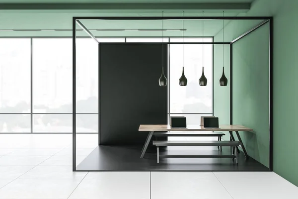 Original panoramic office interior with green walls, tiled floor and long wooden table with benches standing in black and glass room. 3d rendering