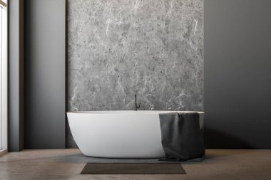 Gri ve beton duvarlar, beton zemin, geniş pencere ve havlu ve yakınında gri halı ile beyaz küvet ile minimalist banyo iç. 3D render