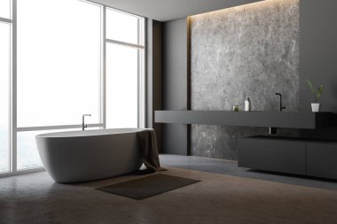 Gri ve beton duvarlar, büyük pencere, beton zemin, havlu ile beyaz küvet ile şık banyo köşesinde ve uzun gri lavabo. 3D render