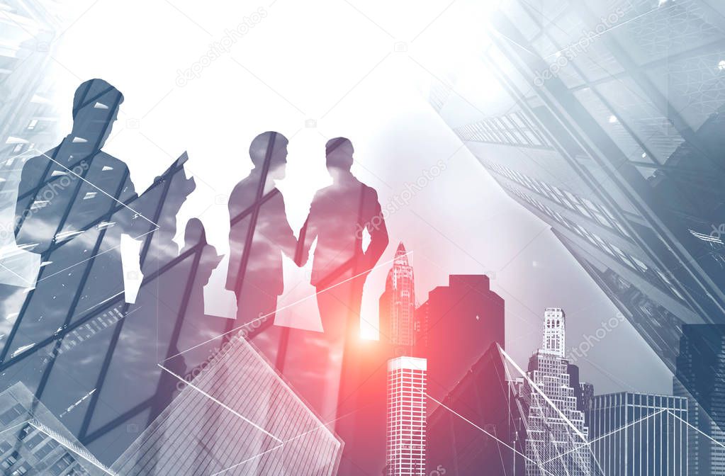 Silhouettes of business people shaking hands and working together in modern city. Concept of business communication. Toned image double exposure