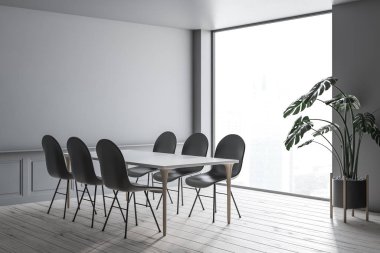 Modern yemek odası ile gri duvarlar, ahşap zemin, tahta bacak ve gri sandalye etrafında ayakta beyaz tabloyla iç. 3D render
