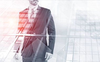 Tanınmayan portresi gökdelen arka plan üzerinde elbise ayakta genç Yöneticisi sakallı. Liderlik kavramı. Tonlu görüntü pozlama sahte katlayın