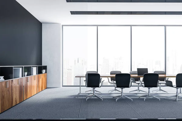 Interior of meeting room with black and white walls, carpet on the floor, panoramic window and long wooden table with gray chairs. Bookcase near the wall. 3d rendering