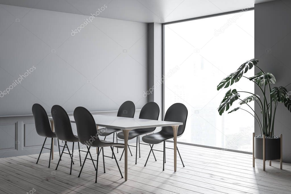 Interior of modern dining room with gray walls, wooden floor, white table with wooden legs and gray chairs standing around it. 3d rendering