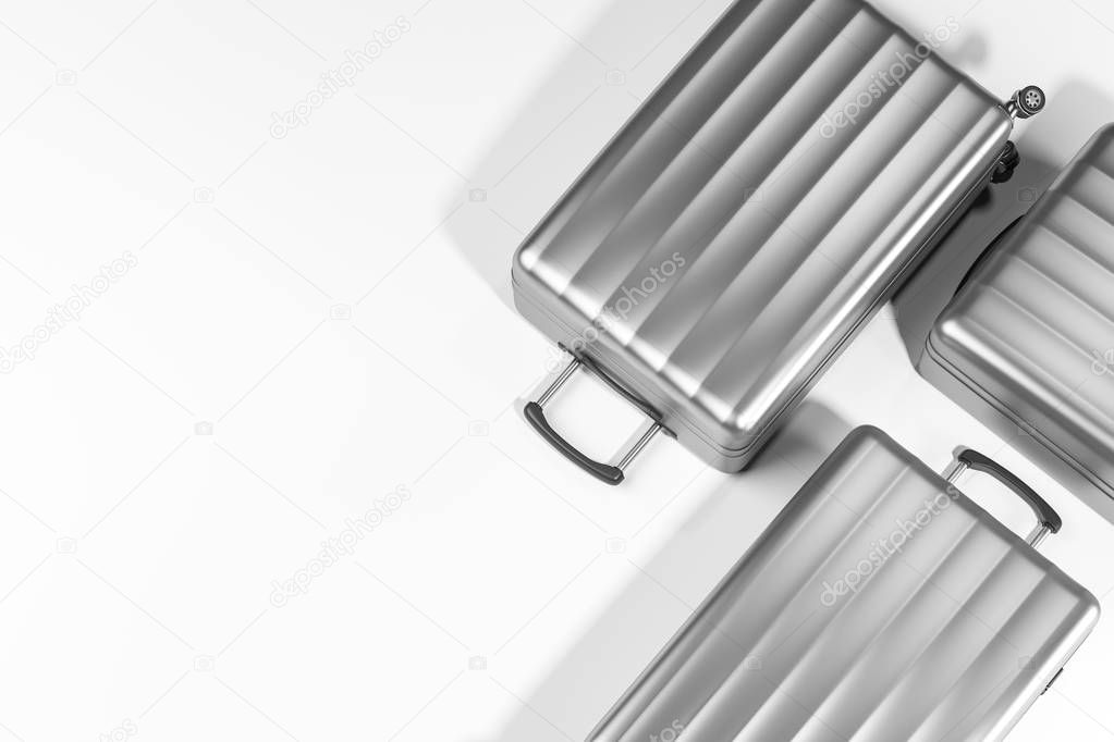 Top view of three stylish silver suitcases lying on white surface. Concept of tourism and travelling. 3d rendering mock up