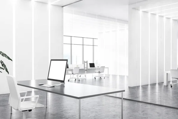 Computer with mock up screen standing in manager office with white walls, concrete floor and gray table. 3d rendering
