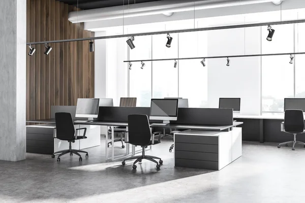 Interior of industrial style office with white and wooden walls, concrete floor, row of white computer desks near window and black computer tables. 3d rendering