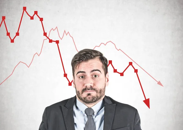 Affärsman shrugging axlarna, fallande graf — Stockfoto