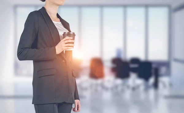 Businesswoman with coffee in meeting room — Stock Photo, Image